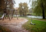 Pusty plac zabaw w parku nad rzeką po deszczu